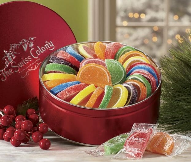 Colorful Fruit Gel Slices arranged in an opened red Swiss Colony tin.