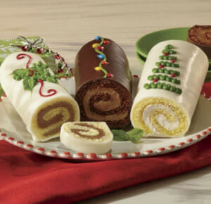 Three Rolled Cake Logs, in White Chocolate, Lemon and Original Chocolate, each decorated with a Christmas design.