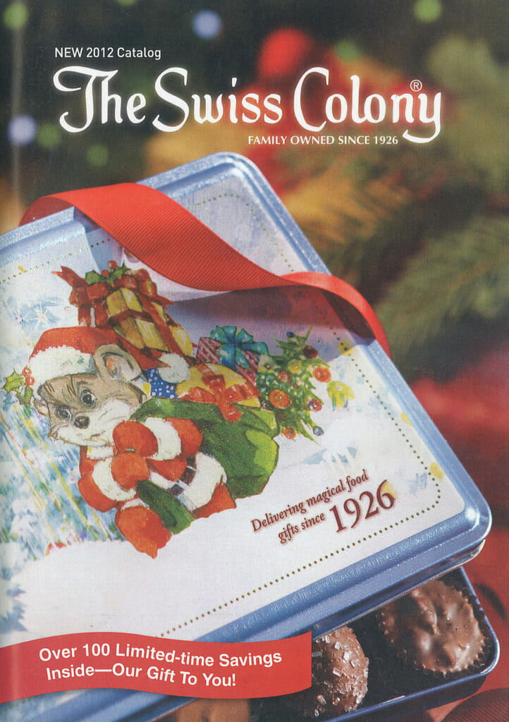 Holiday 2012 Swiss Colony Catalog Cover -   Chris Mouse Christmas tin partially open full of chocolates 