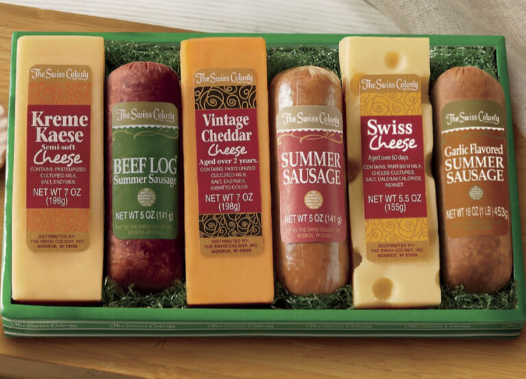 A variety of summer sausage logs and cheese bars in a green and white gift box.