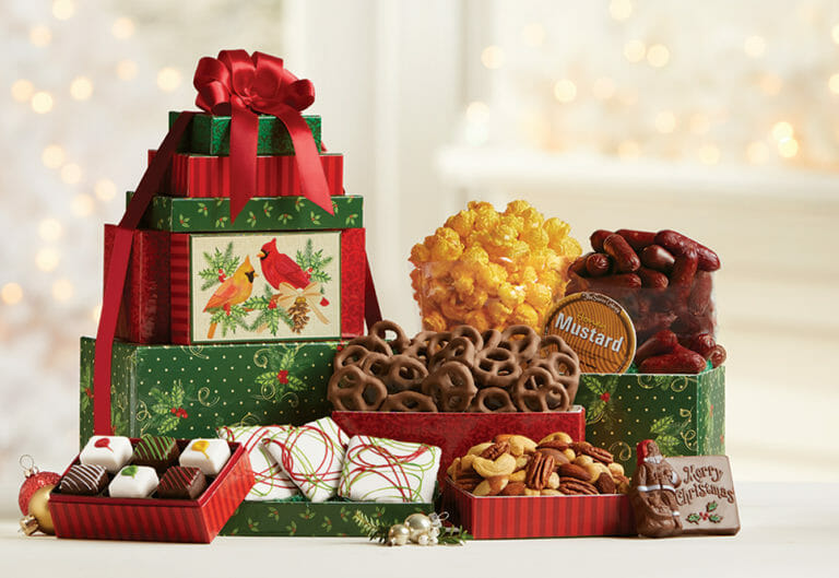 Cardinal Tower Christmas gift boxes filled with popcorn, chocolates, Petits Fours, nuts, sausage, and mustard.