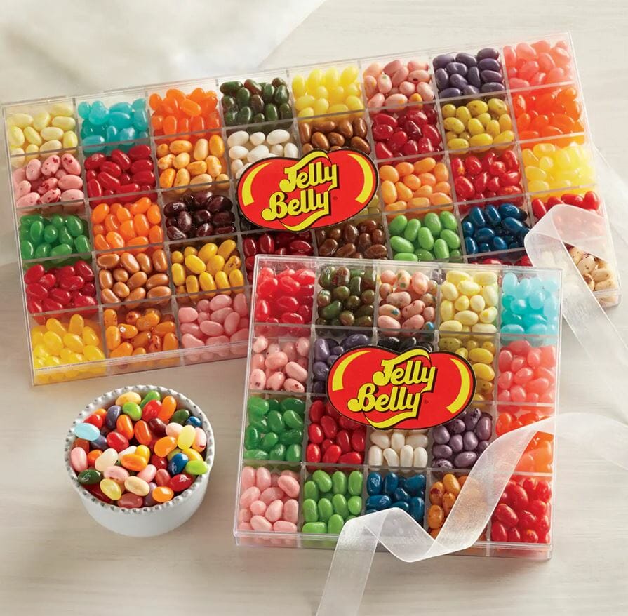 Two sizes of clear divided containers filled with assorted colors of jelly belly jelly beans, and a white bowl of samples.