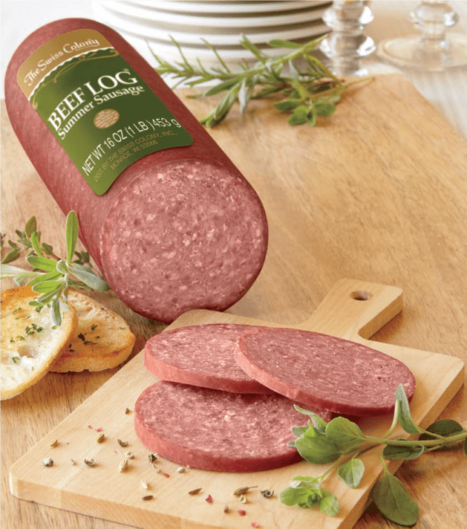 Sliced beef log summer sausage with slices of sausage and garlic bread on a cutting board.