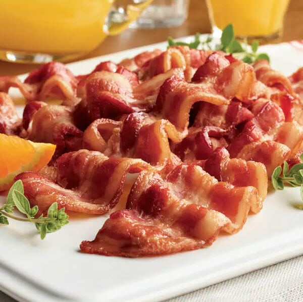 Thick cut bacon on a white platter